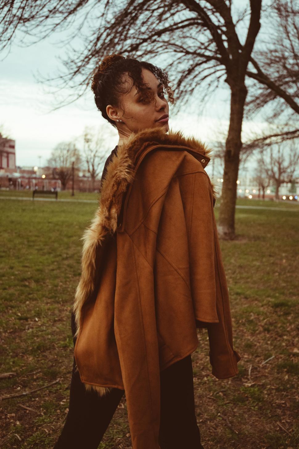 Free Image of Chic person in trendy coat walking outdoors 