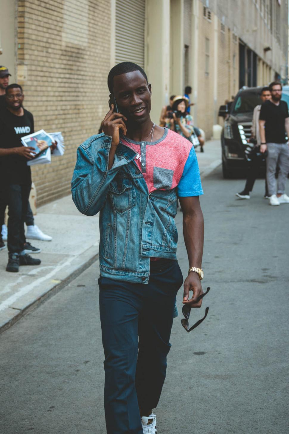Free Image of Man walking and talking on phone in city 