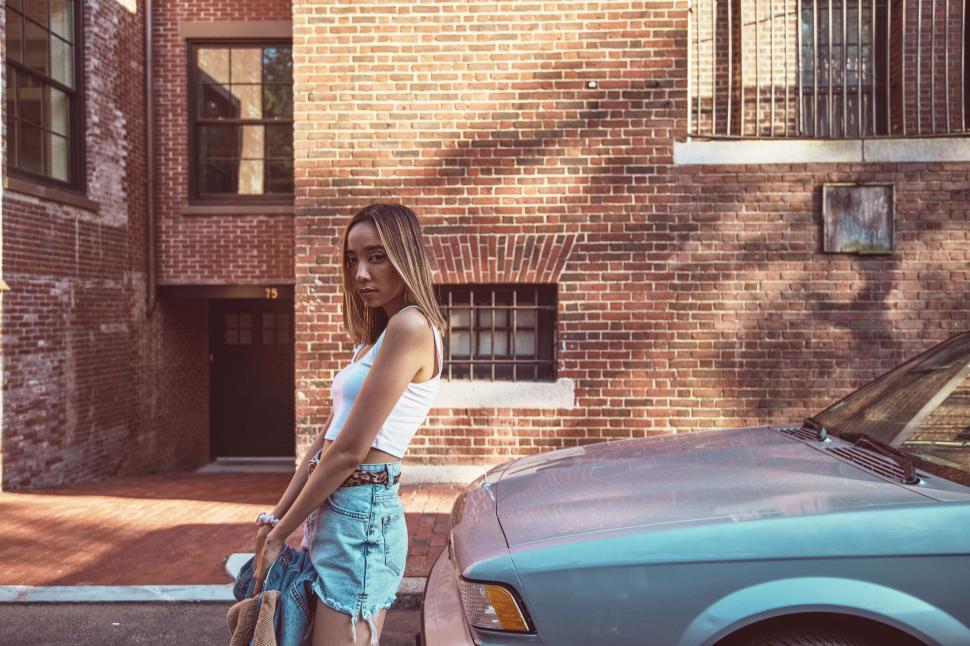 Free Image of Young Woman by Classic Car 
