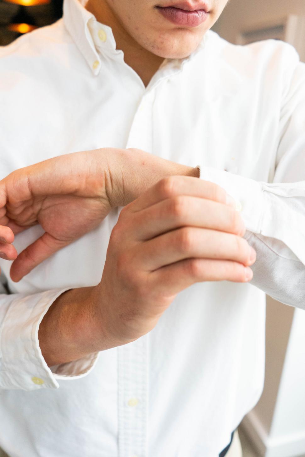 Free Image of Close-up of a man buttoning cuffs 