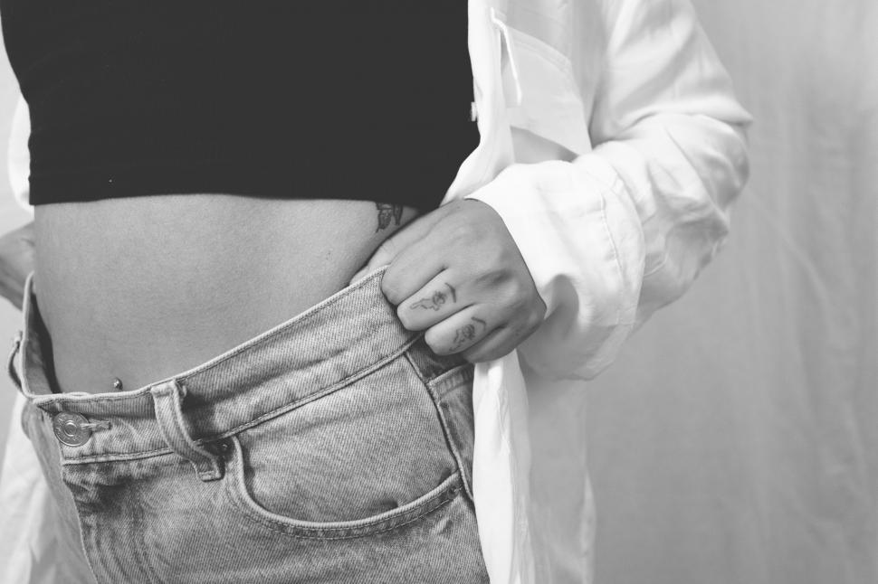 Free Image of Person tucking in a shirt 