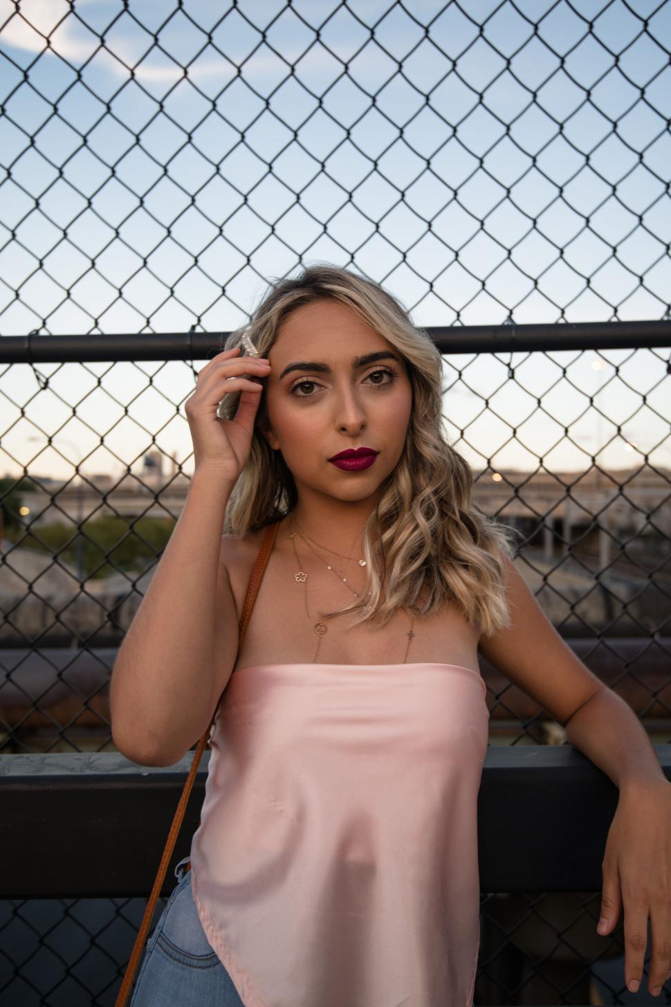 Free Image of Woman with dramatic backdrop in urban setting 