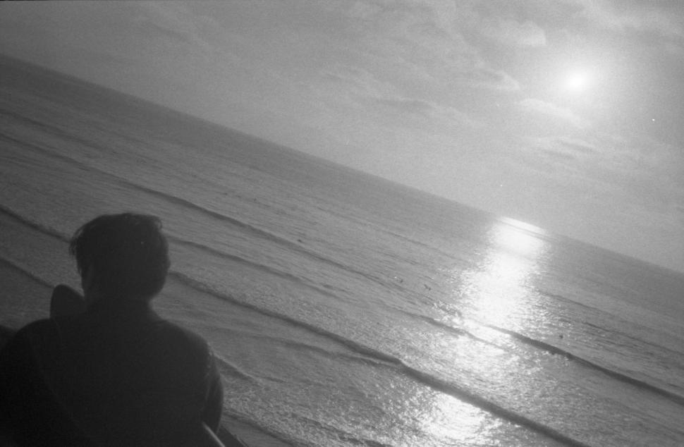 Free Image of Person watching sunset over the ocean 