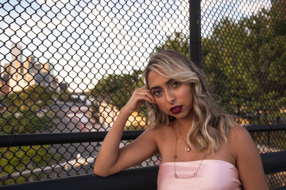 Free Image of Woman with red lipstick on cityscape backdrop 