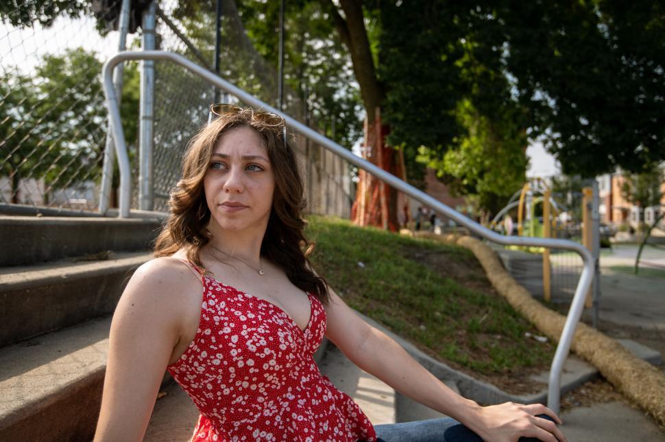 Free Image of Woman sitting on steps outdoors 