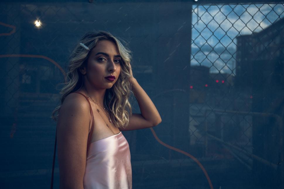 Free Image of Young woman in urban nighttime scene 