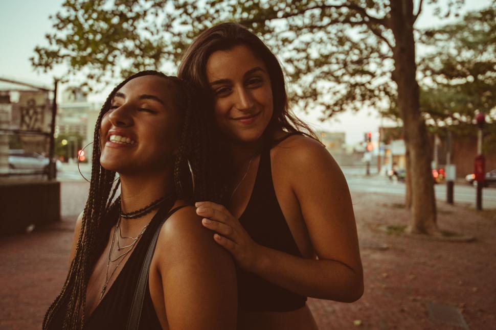 Free Image of Two friends embracing in evening light 