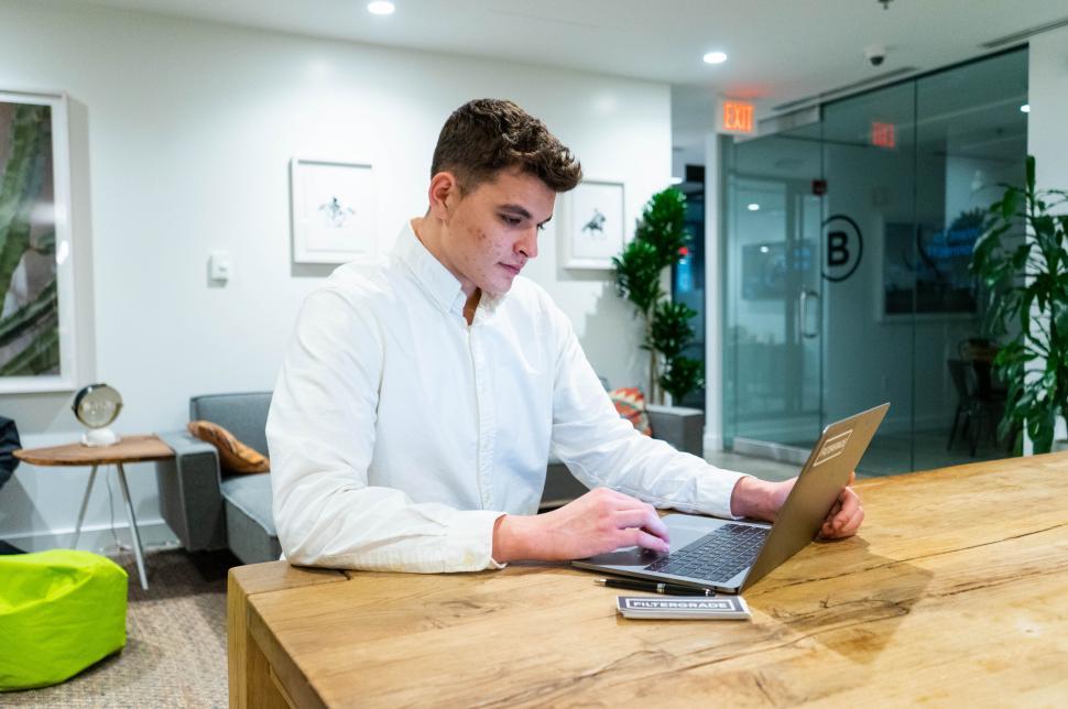 Free Image of Man working on laptop in modern office 