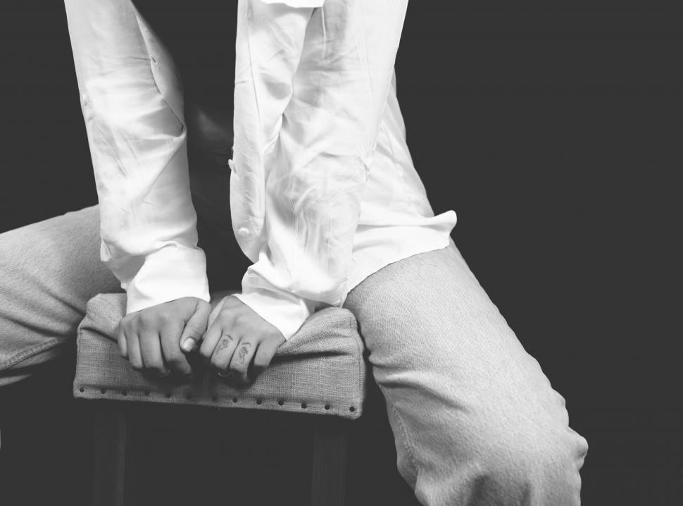 Free Image of Person sitting in white attire on chair 