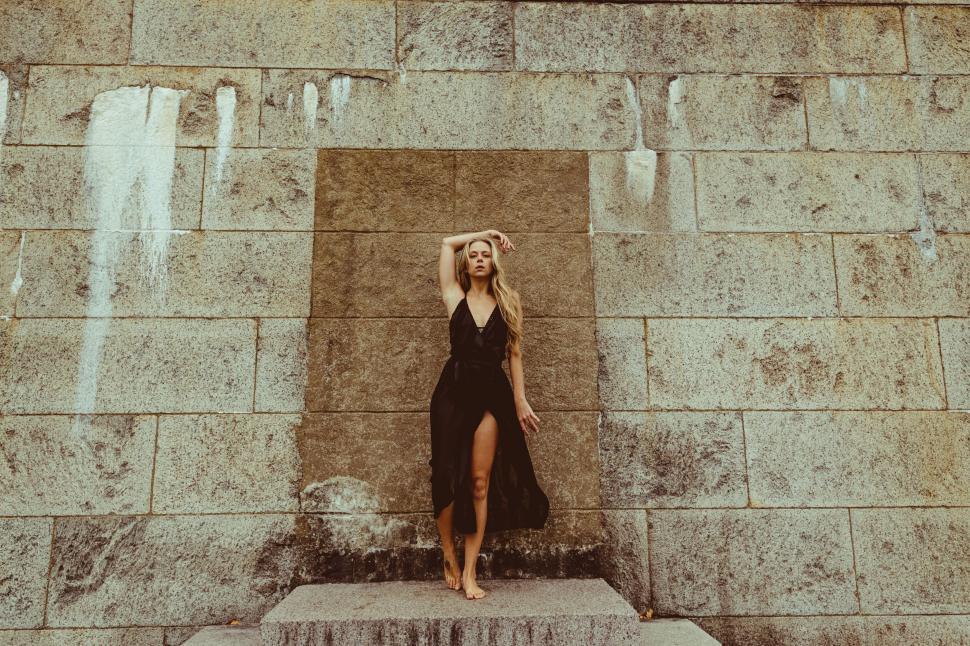 Free Image of Woman by graffiti-covered wall in city 
