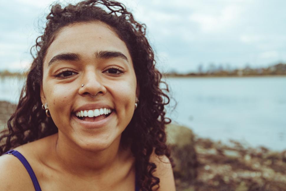 Free Image of Warm smile on waterside woman s face 