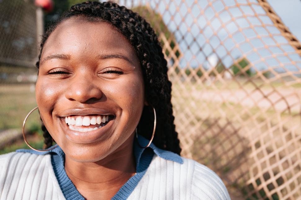 Free Image of Joyful expression in sunlit city park 