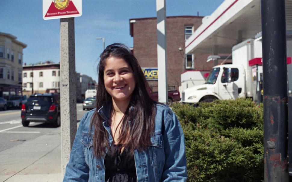 Free Image of Smiling woman on urban street side 