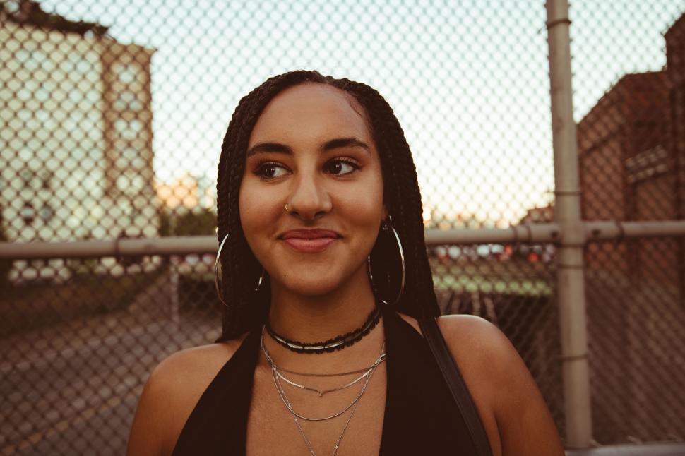 Free Image of Woman with braids smiling at sunset 