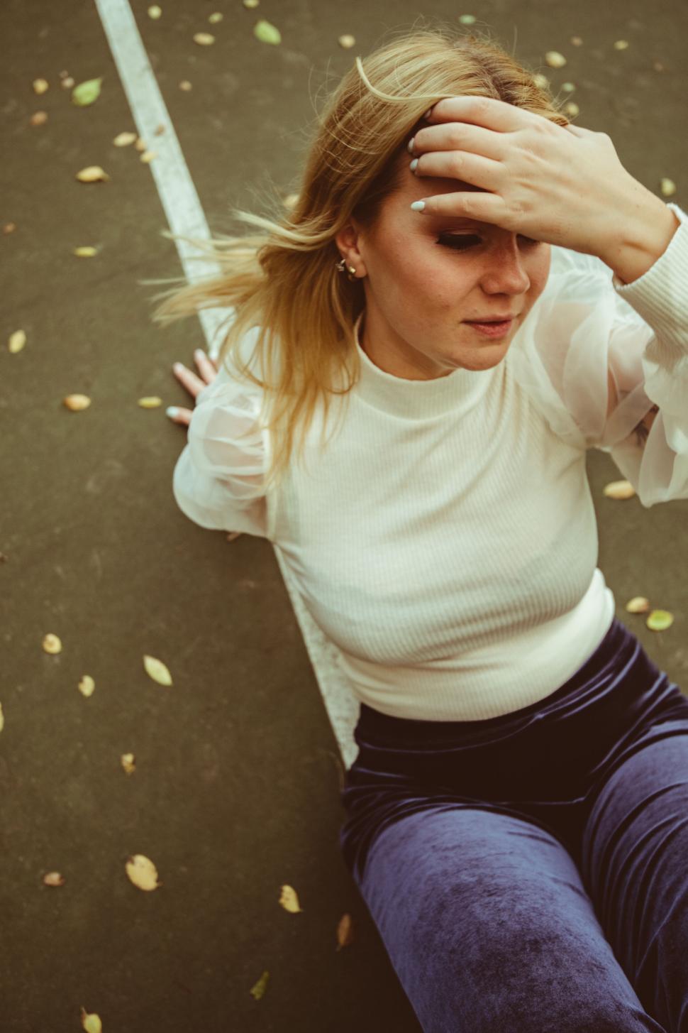 Free Image of Woman shielding her eyes from the sun 