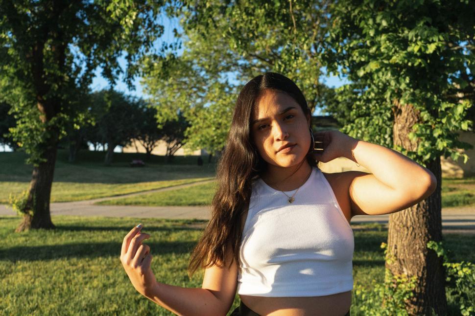 Free Image of Woman touching hair with sunset light 