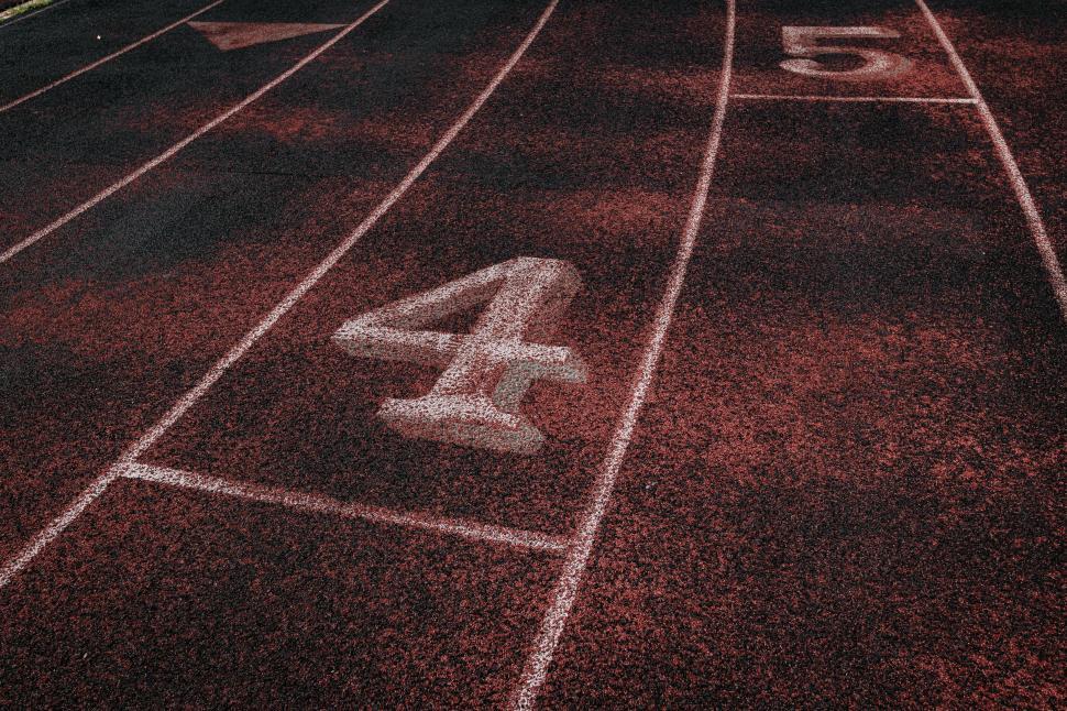 Free Image of Number four on red running track 