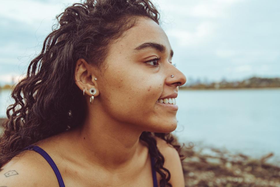 Free Image of Young woman smiling by the water 