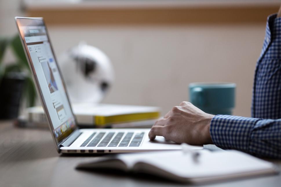 Free Image of Working on laptop with notes and cup 
