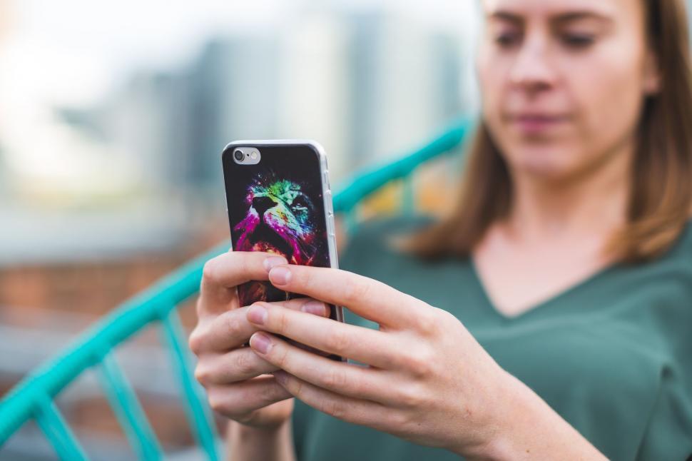Free Image of Woman using smartphone with vivid cover 