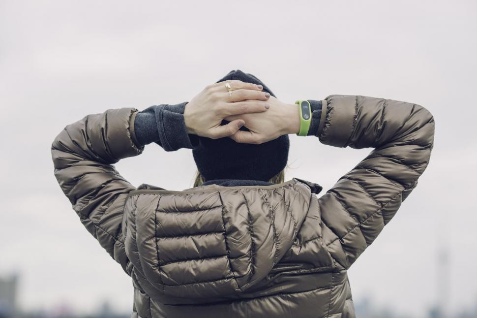 Free Image of Woman with arms raised behind head 