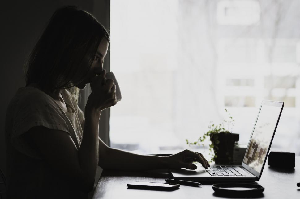 Free Image of Unrecognizable person sitting at a laptop 