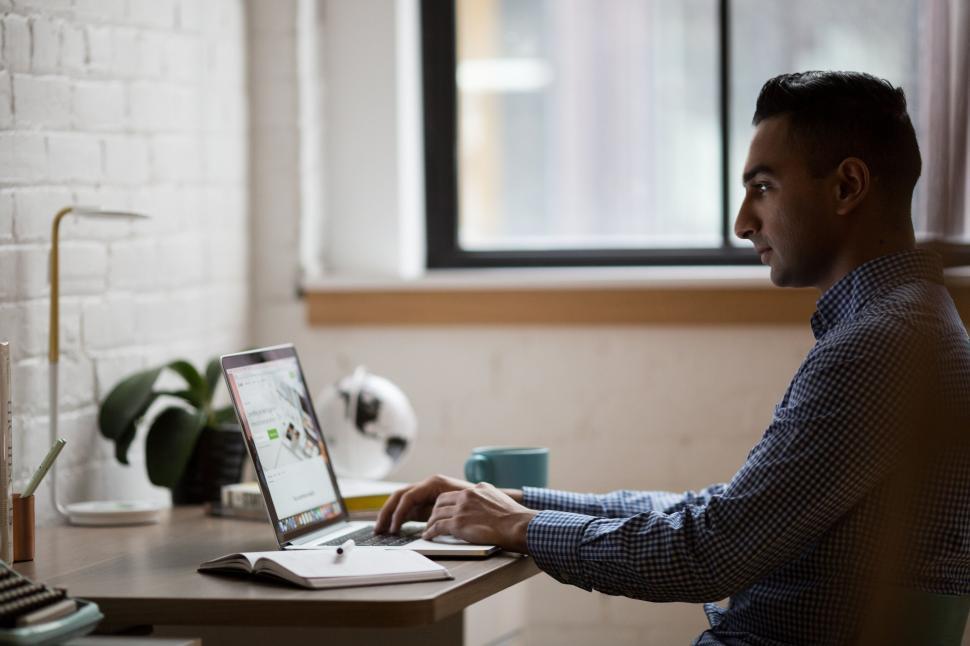Free Image of Professional working on a laptop in an office 