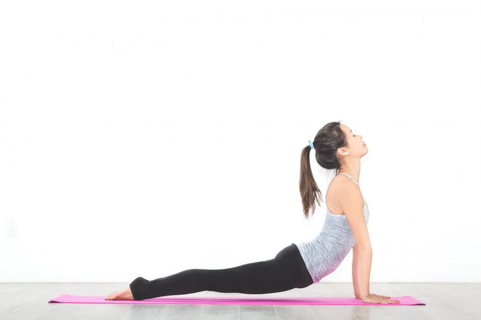 Free Image of Woman practicing yoga in a bright studio 
