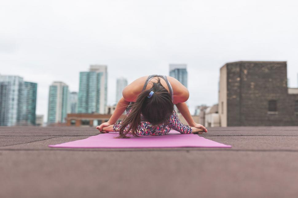 Free Image of Woman practicing yoga in urban setting 