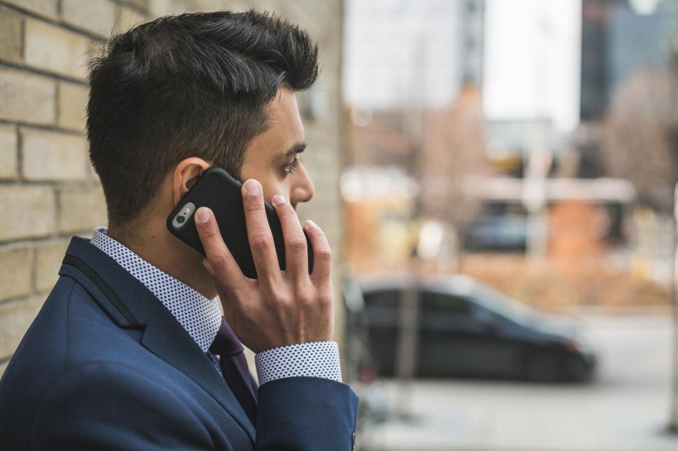 Free Image of Man talking on the phone in the city 