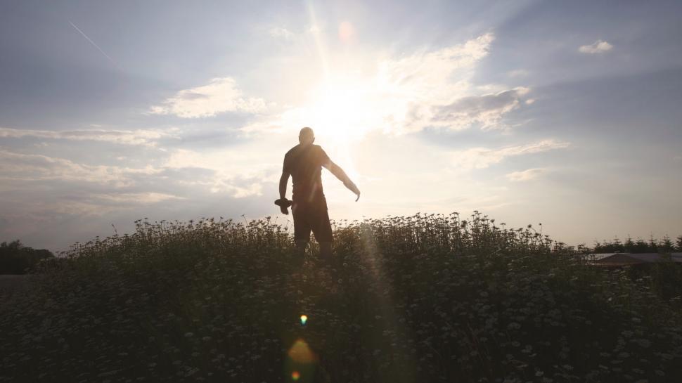 Free Image of Silhouette of man walking in the sunset 