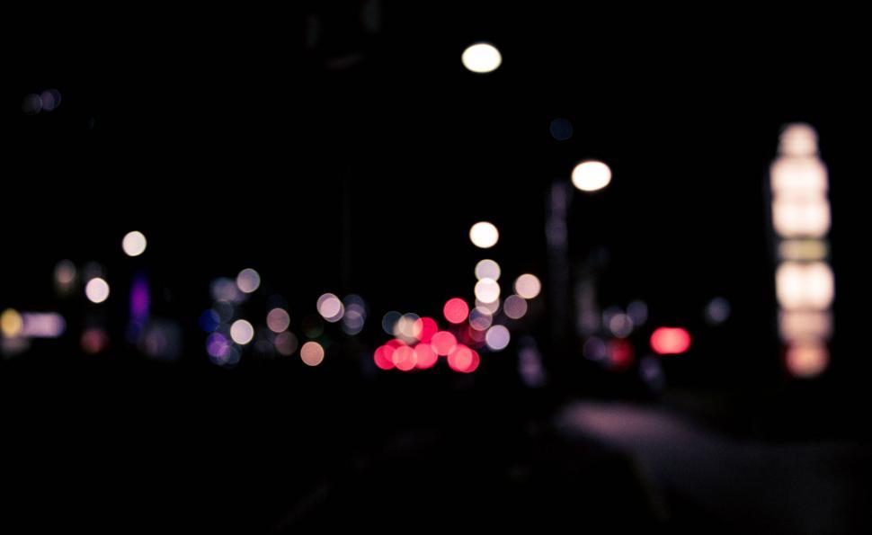 Free Image of Blurred lights of a city street at night 