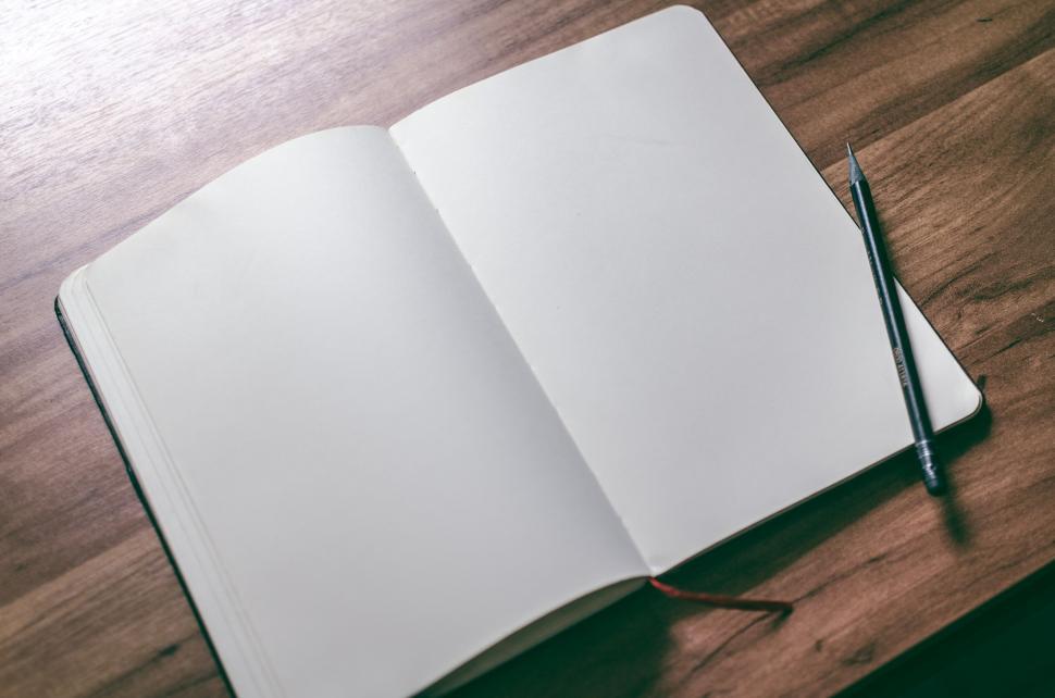 Free Image of Open blank notebook with pencil on wooden surface 