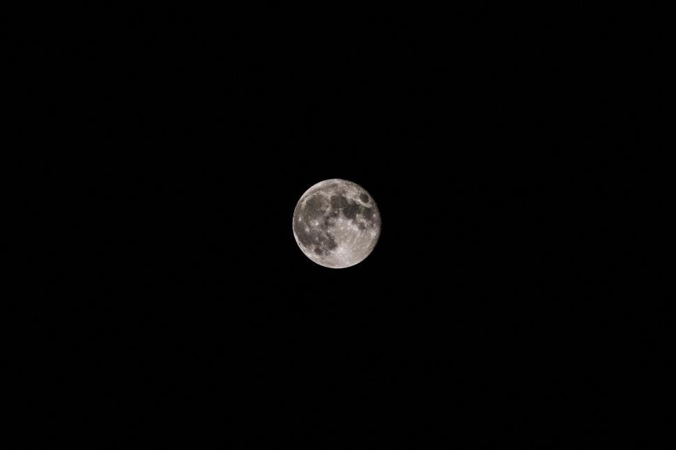 Free Image of Full moon shining in the dark night sky 