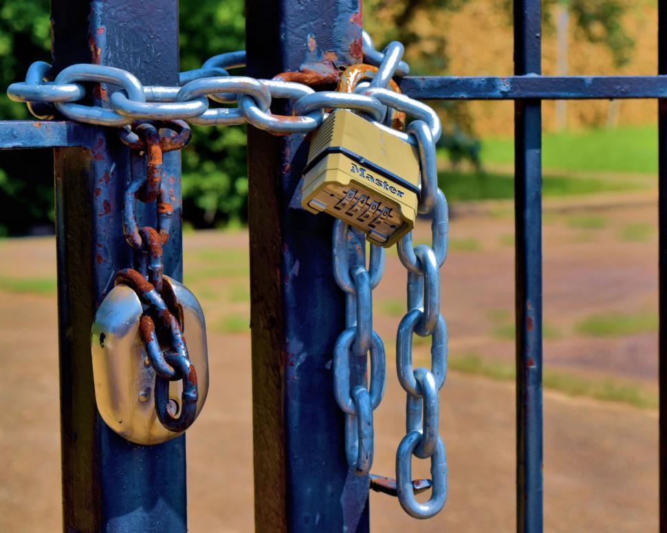Free Image of Padlocks securing a blue metal gate 