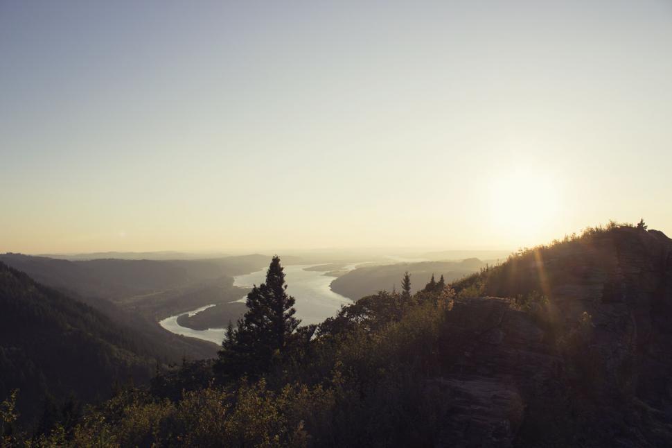 Free Image of Sunset over a serene river landscape 
