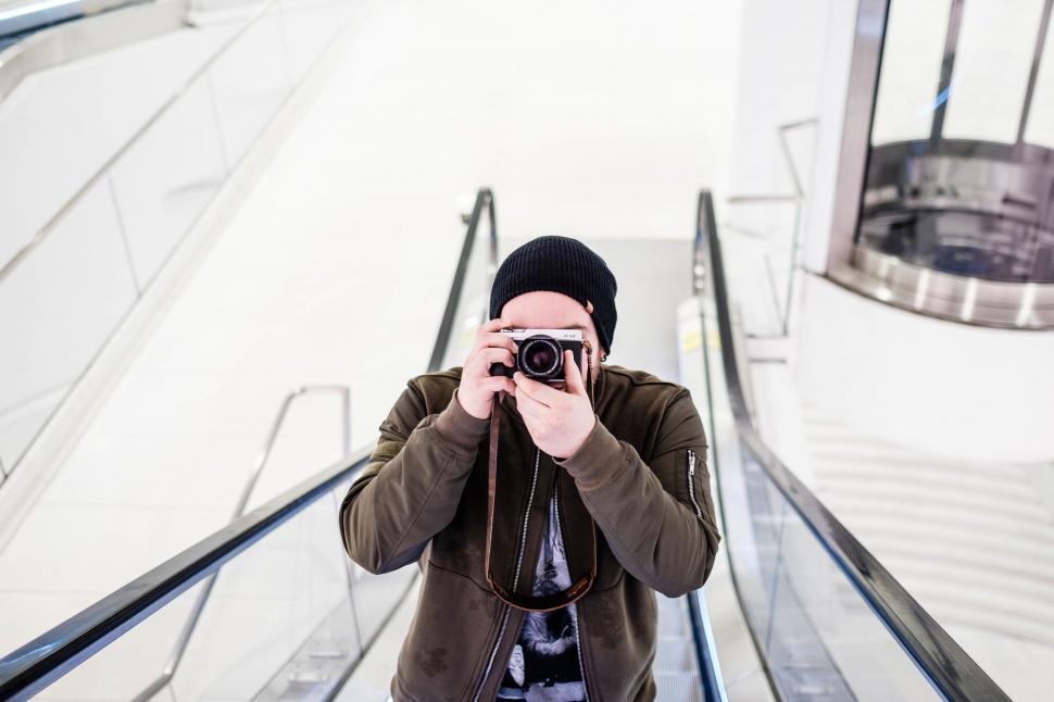 Free Image of Outdoor escalator ride with blurred face 