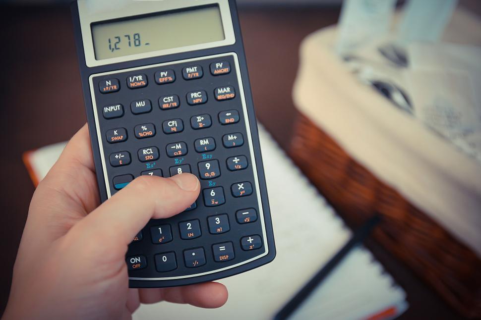 Free Image of Hand holding calculator with visible amount 