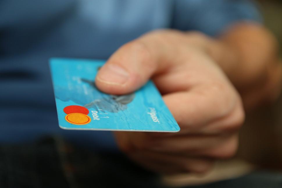 Free Image of Blurred credit card in hand emphasis on card details 