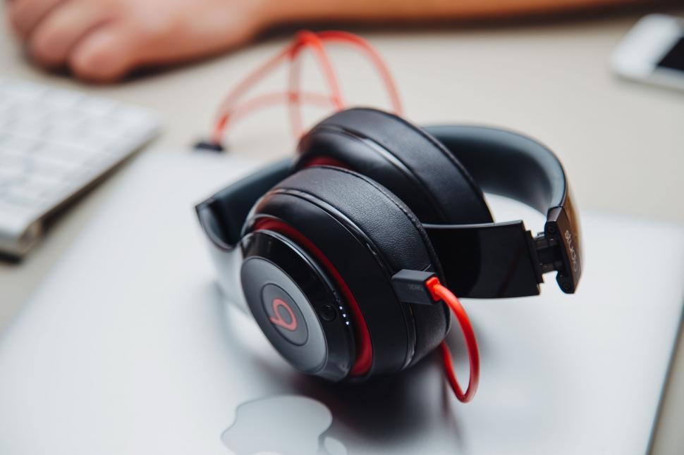 Free Image of Black headphones resting on a laptop 