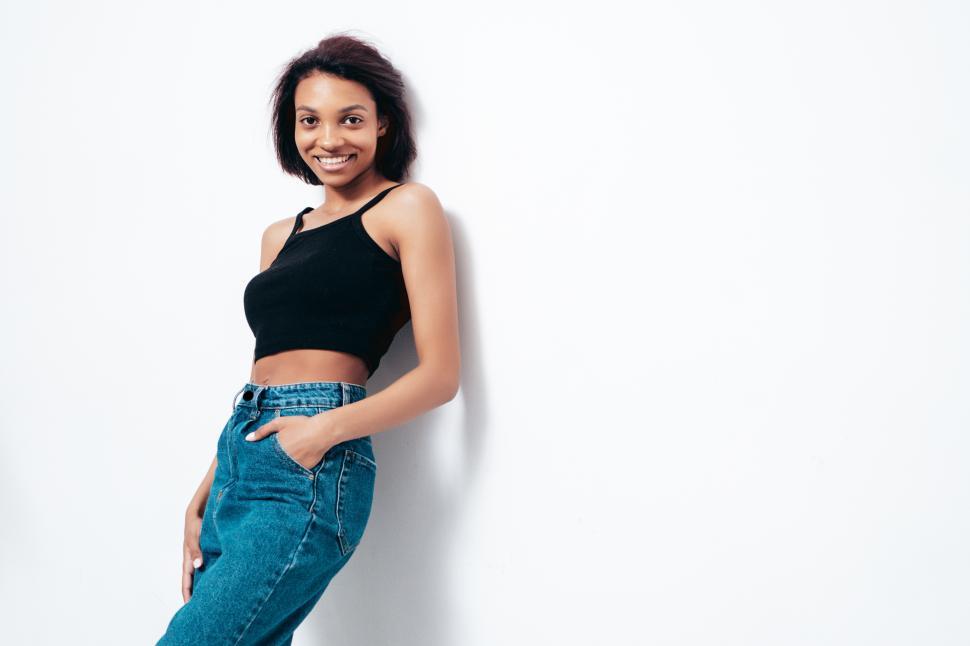 Free Image of A woman leaning against a wall 