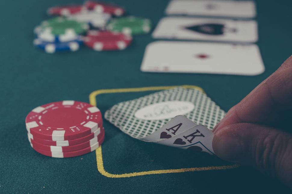 Free Image of Hand revealing ace of spades in poker game 