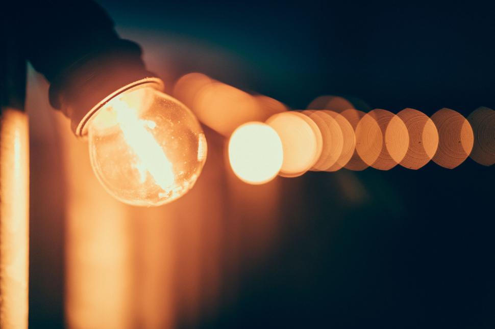 Free Image of Bright light bulb string glowing in the dark 