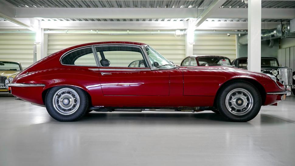 Free Image of Classic red Jaguar E-Type car in showroom 