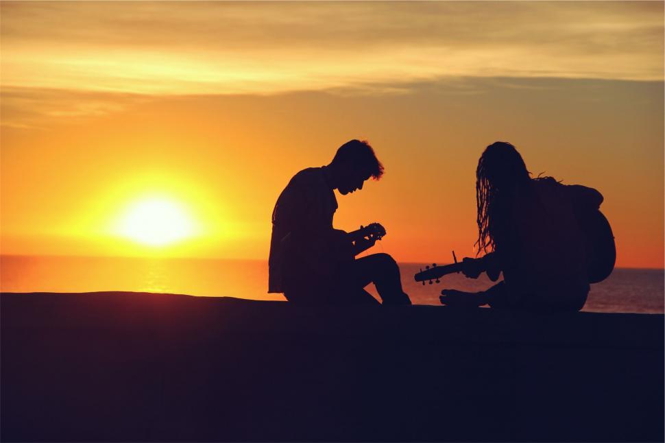 Free Image of Silhouette of two people playing guitars 
