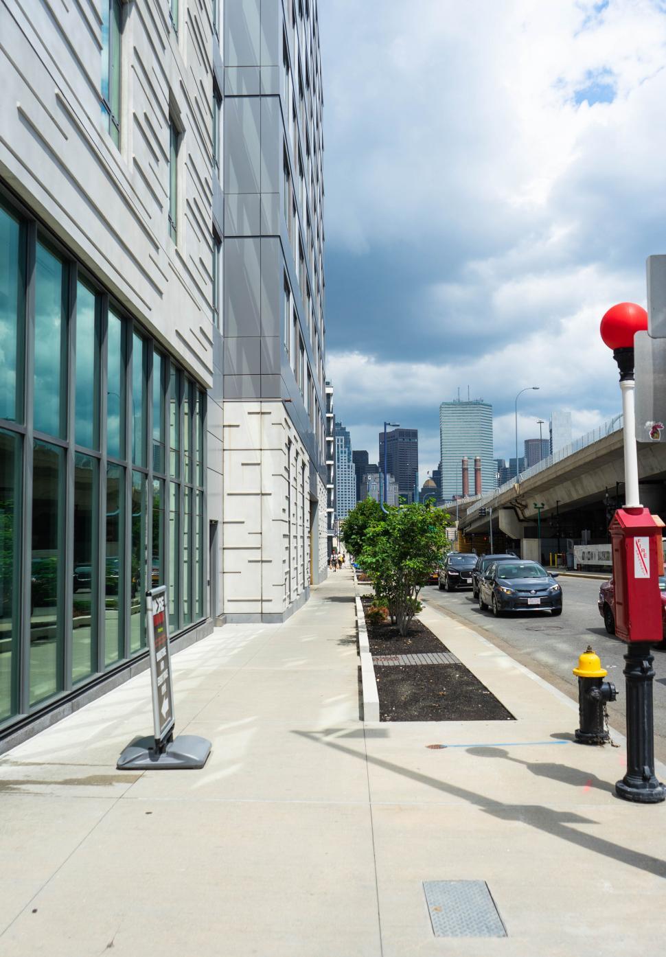 Free Image of Sidewalk along modern buildings with city view 