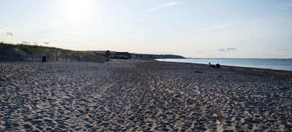 Free Image of Sunset casting shadows on sandy beach 