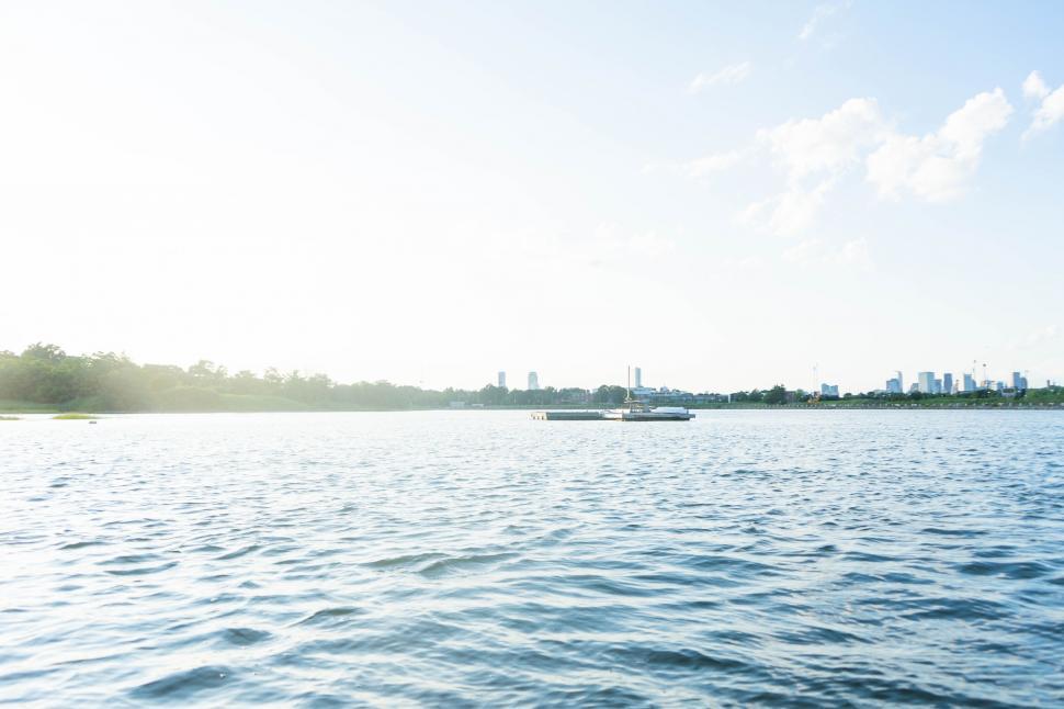 Free Image of Bright sunny view over peaceful city river 