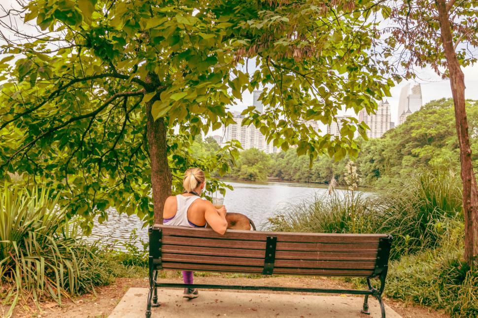 Free Image of Woman and dog enjoying peaceful park 