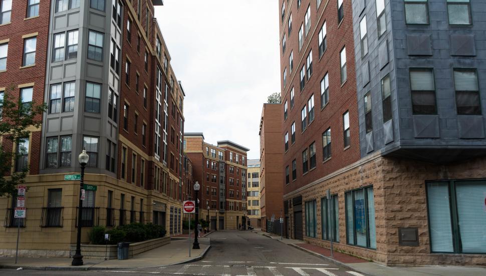 Free Image of Empty city street between tall buildings 